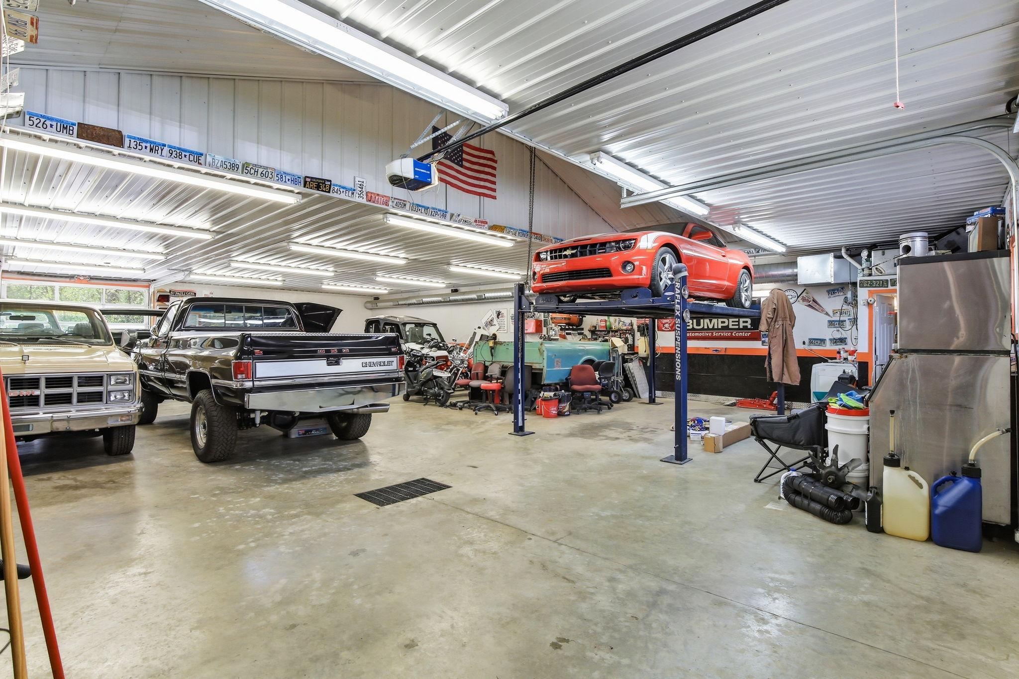 Fully finished shop space with heat and A/C, high ceilings, and room for vehicles, equipment, and projects.