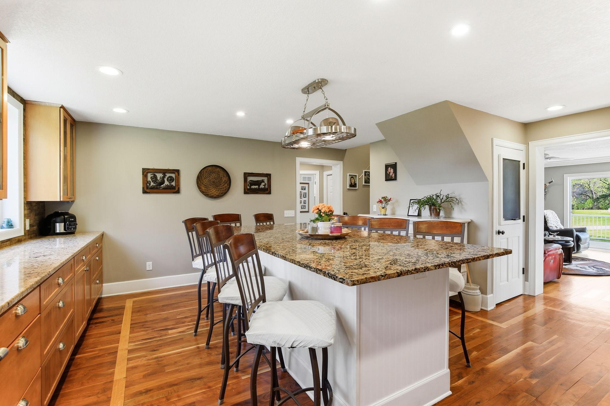Black walnut floors with white oak inlay add character and carry through the Kitchen and dining space.