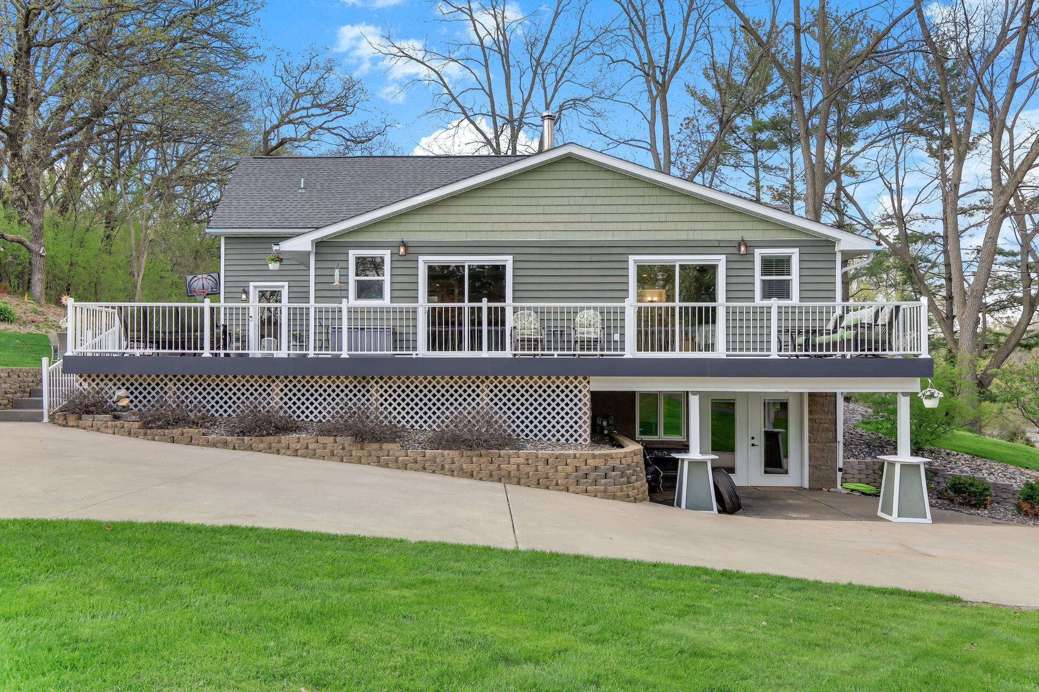 Walkout home with full-length deck overlooking the yard and surrounding acreage.
