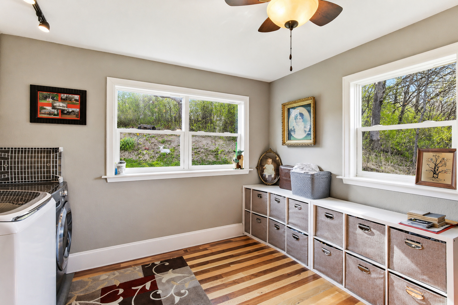 Bright Laundry Room with built-in storage, folding space, and durable wood flooring. This could also be used as a craft or office room.
