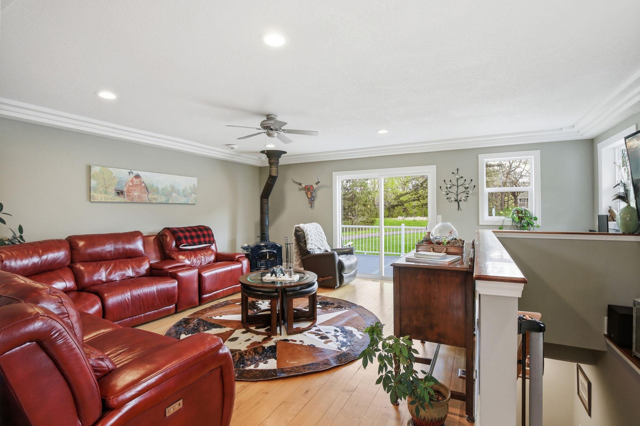 Bright Living Room with hardwood floors, recessed lighting, and walkout to the Deck.