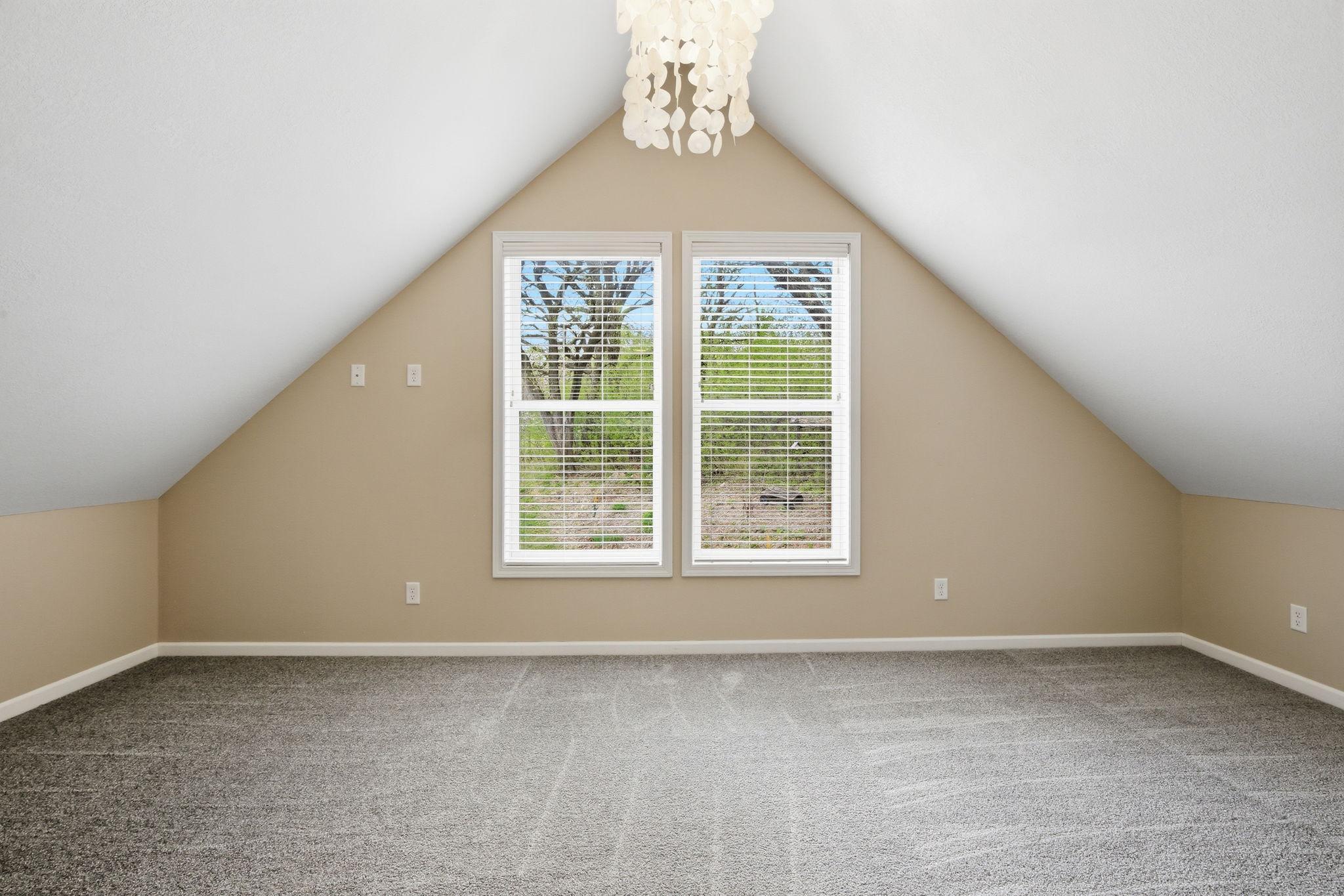 Upper Bedroom with vaulted ceiling, large windows, new carpet and great natural light.