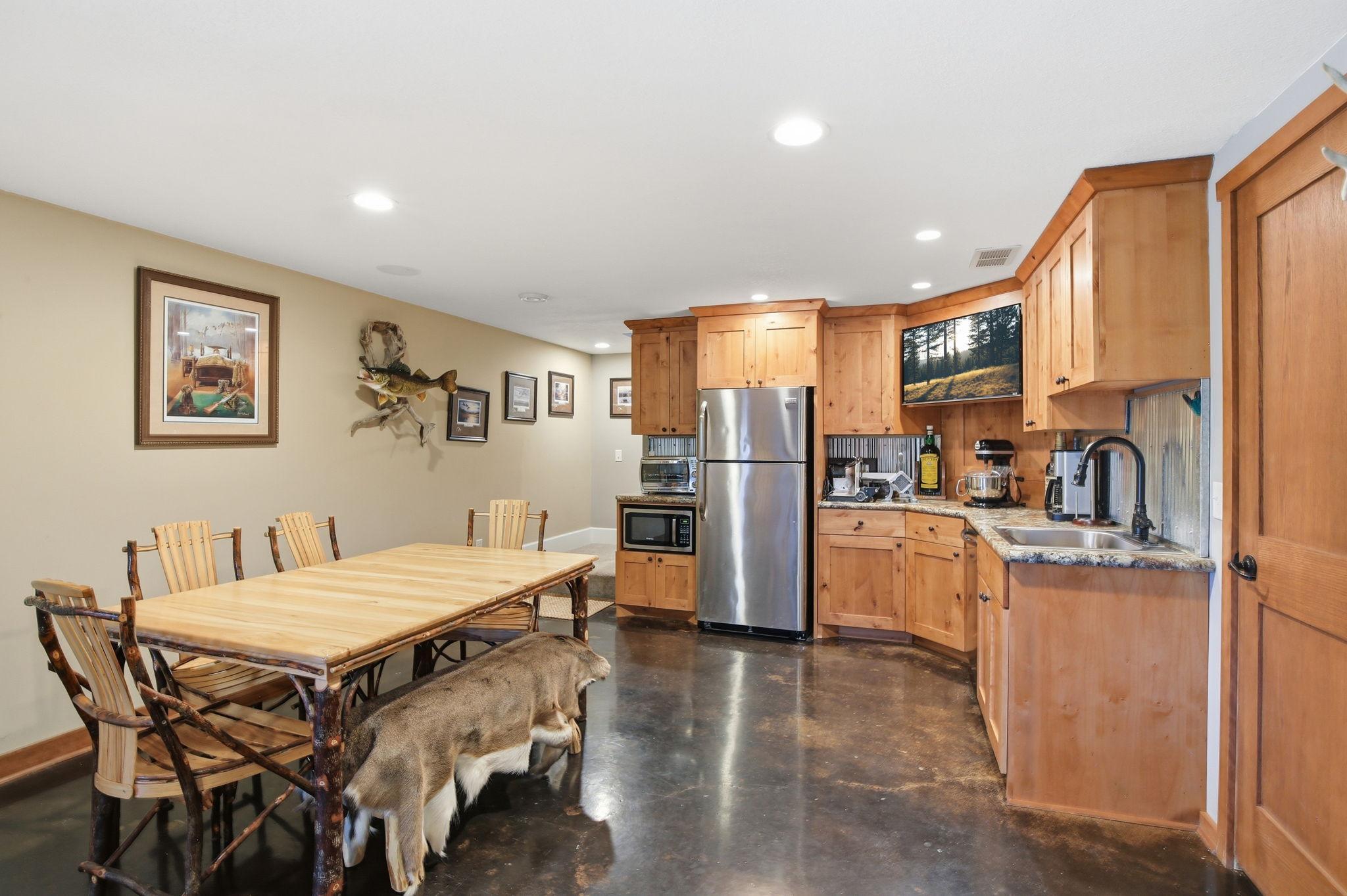 Great Kitchenette with stained concrete flooring, recessed lighting and wonderful space for entertaining.