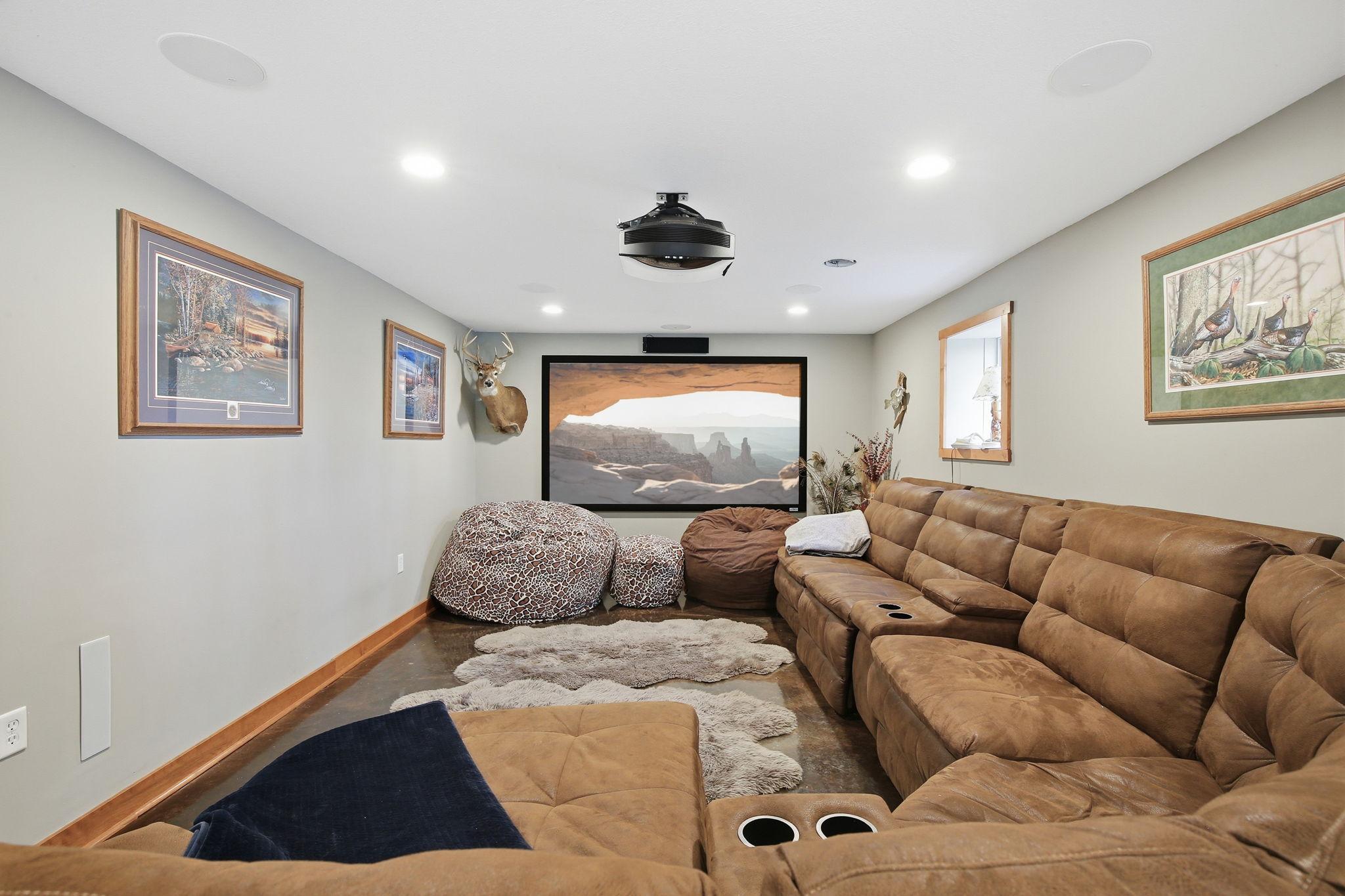 Private Theater Room setup - perfect for movie nights and relaxing. There is an egress window in this area if you wanted to section off space for another bedroom.
