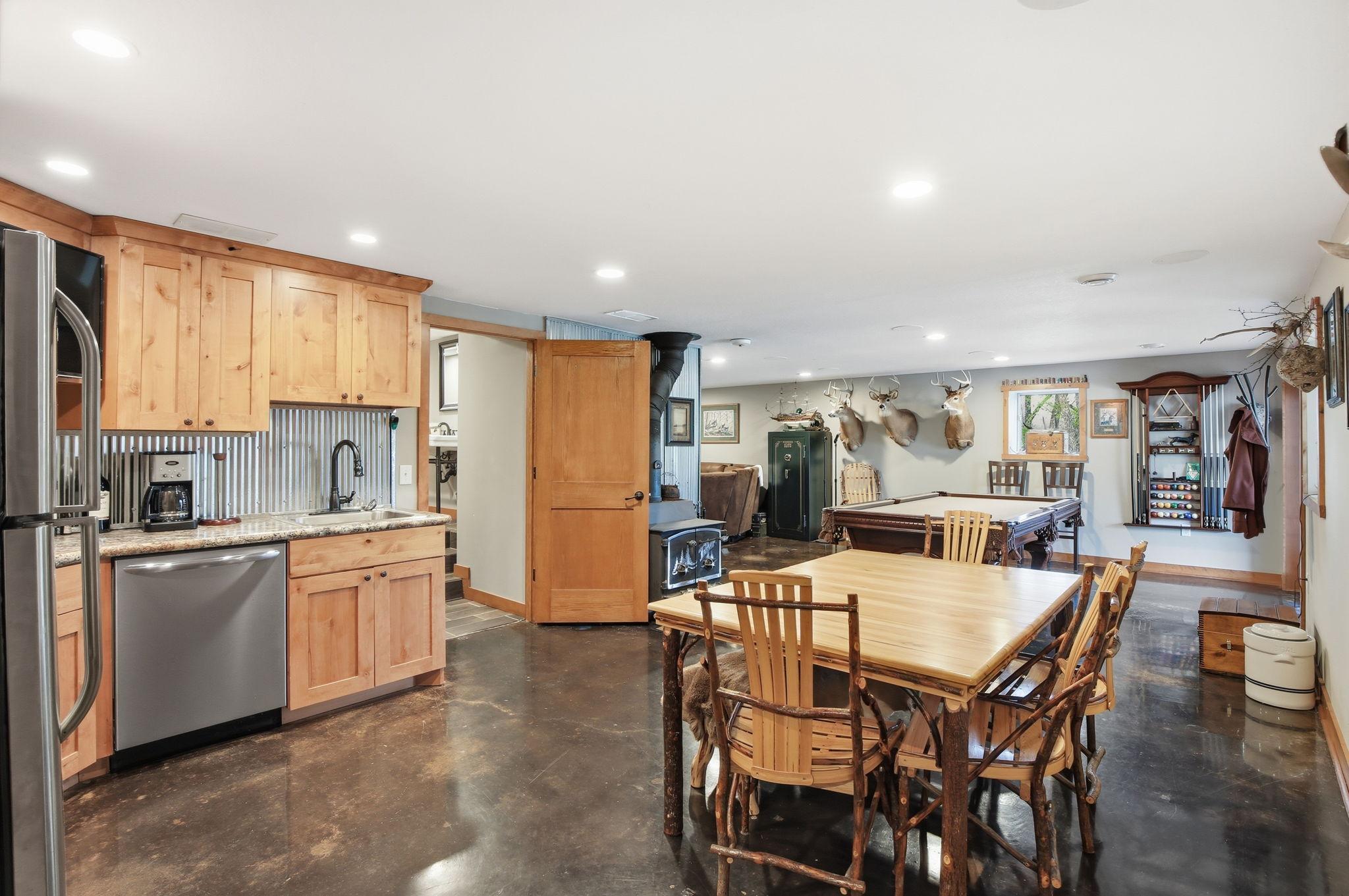 Lower Level Kitchenette with custom cabinetry, stainless appliances and space for entertaining.