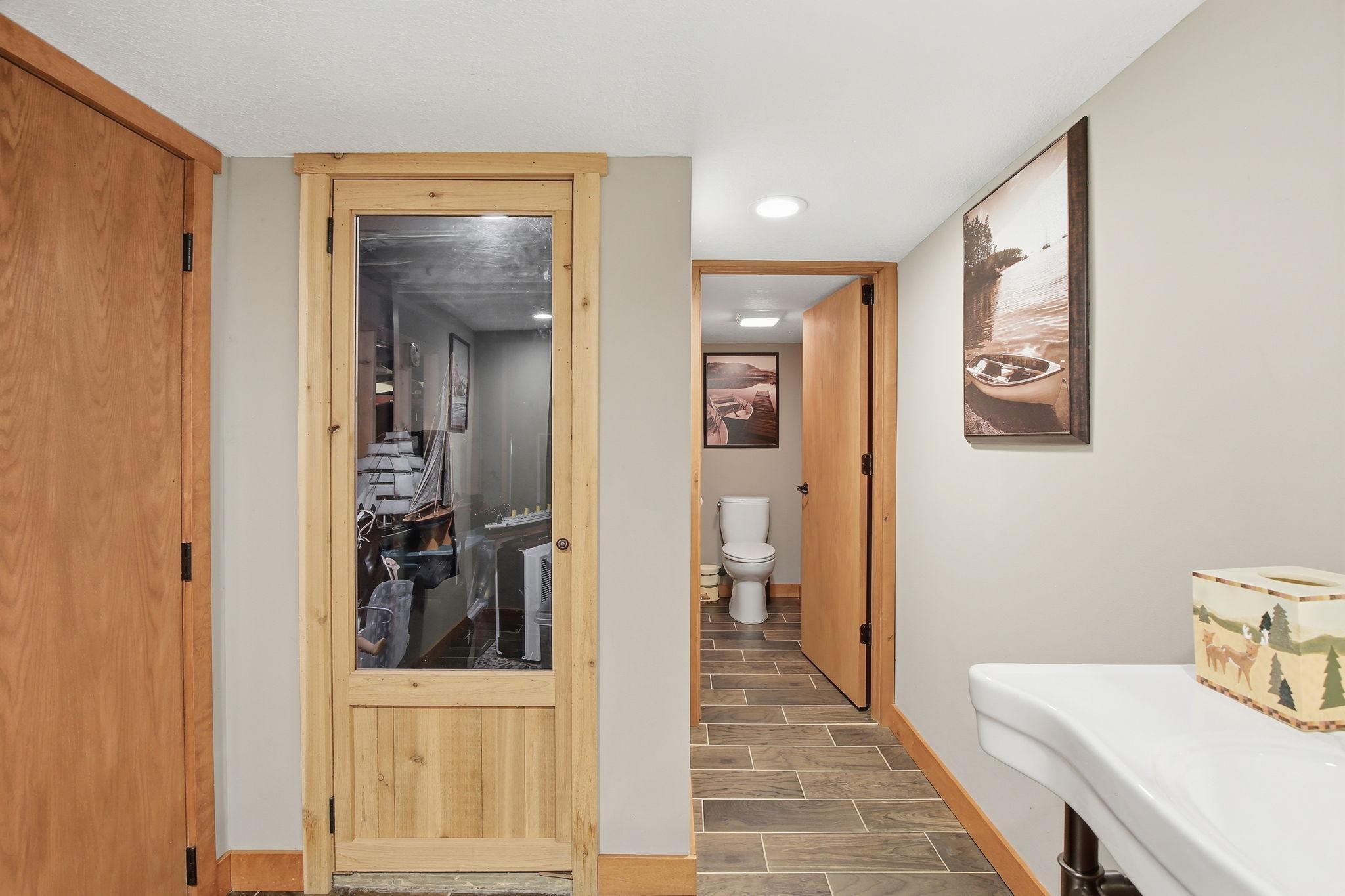 Lower Level hallway with access to 1/2 bath and a future sauna room or make it into a shower room.
