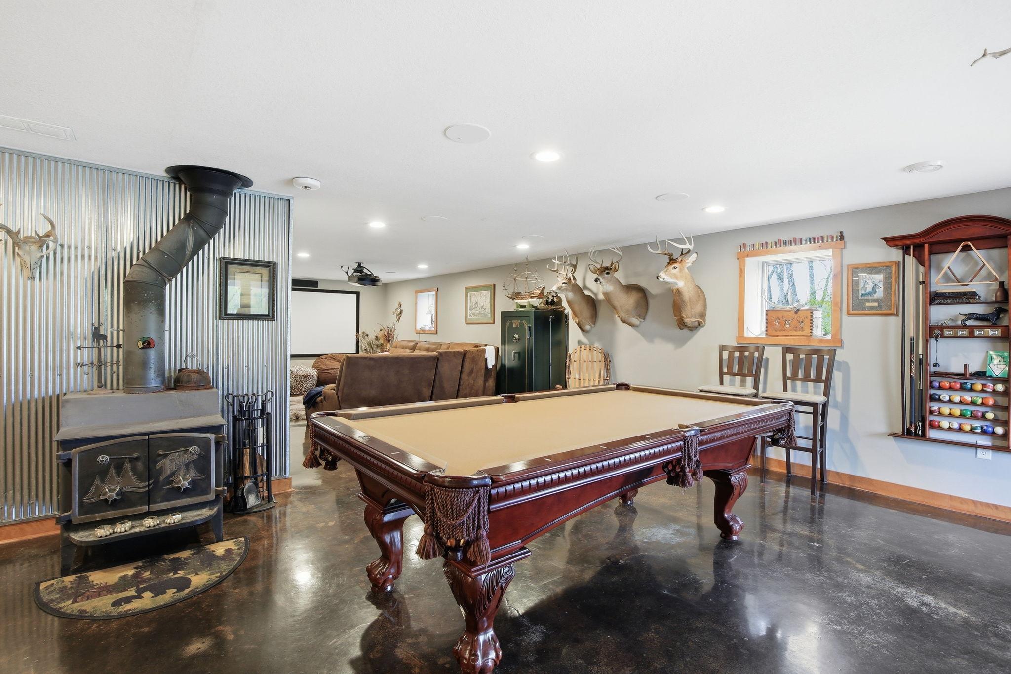 Large Rec Room with pool table space, wood stove, and flexible layout for gatherings.