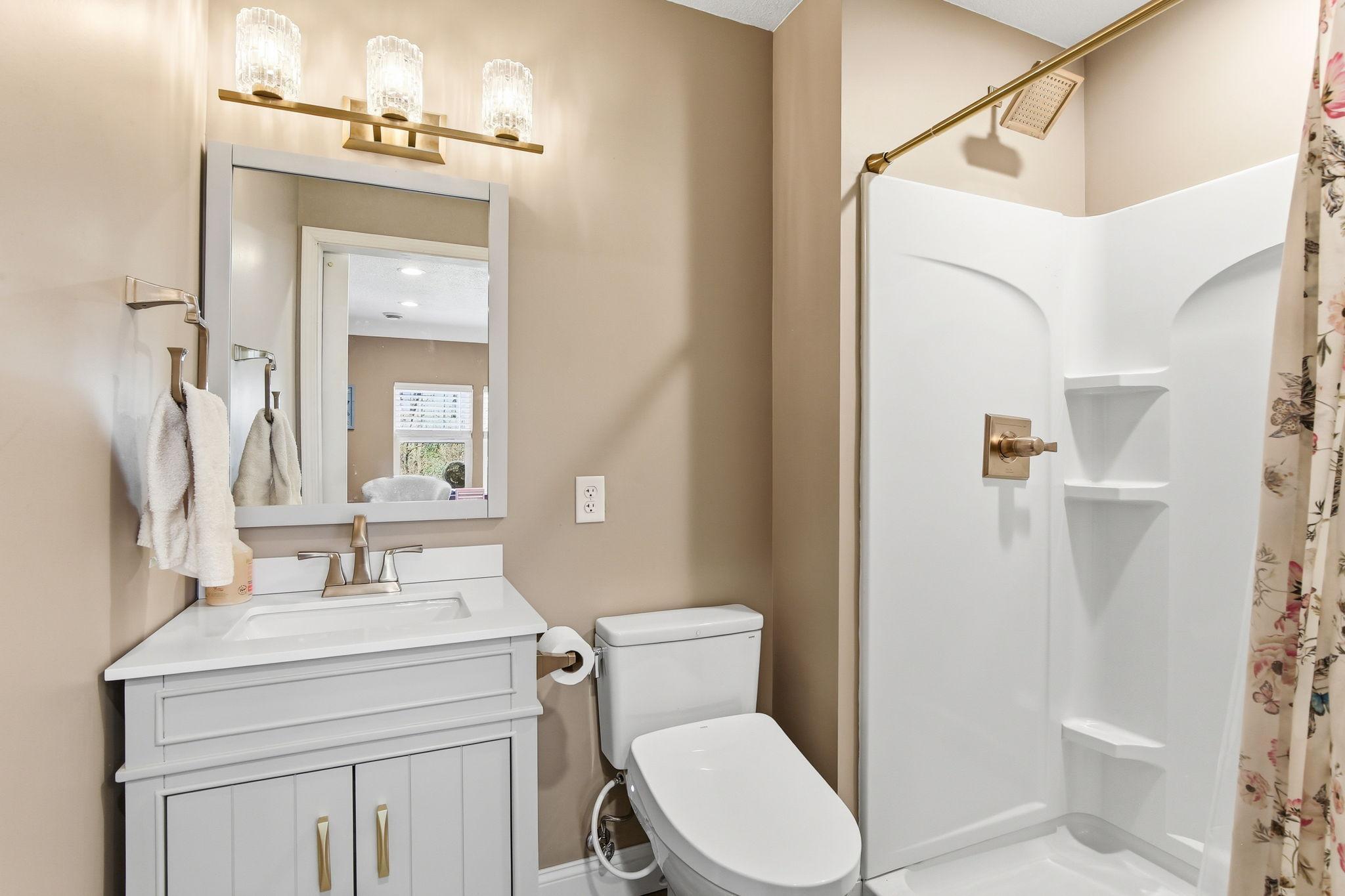 3/4 Bath in the room above the garage with updated vanity and walk-in shower.