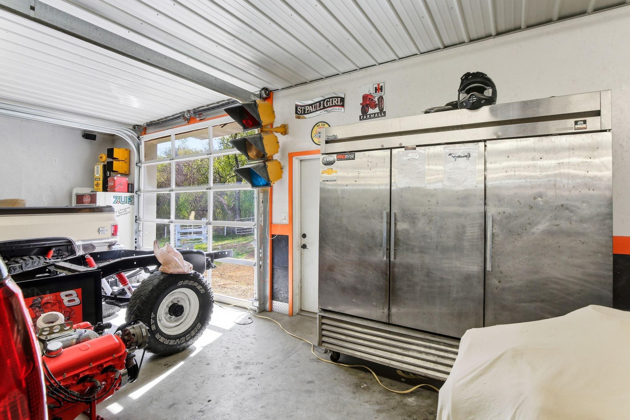 Extra Garage Bay with overhead door and space for equipment, toys, or additional parking.