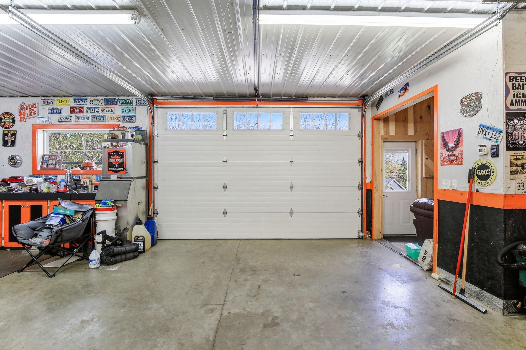 Spacious Heated Garage/Shop with high ceilings and room for multiple vehicles or projects.