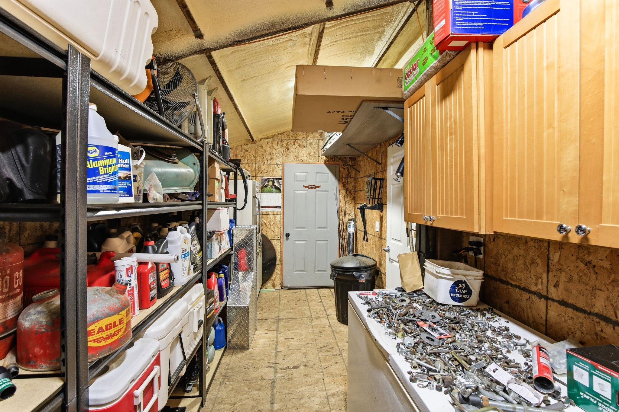Dedicated Storage/Work Area with shelving and workspace for tools, equipment, and supplies.