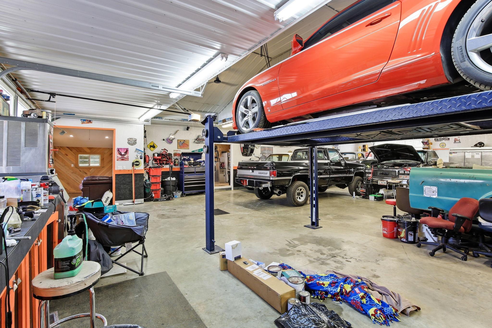 Impressive Shop space featuring a vehicle lift - perfect for car enthusiasts or serious hobbyists.