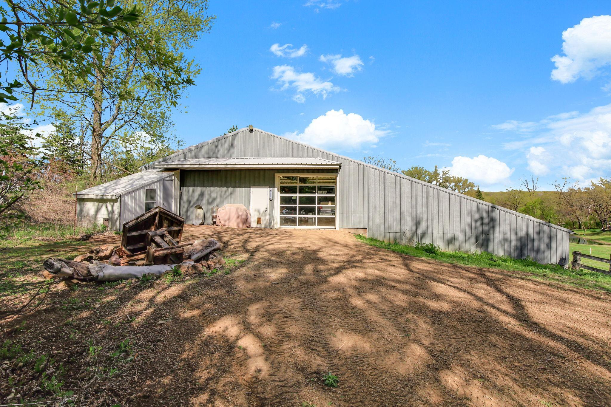 View from the back of the Shop with multiple stalls down below - suited for animals, storage, or hobby farm use.
