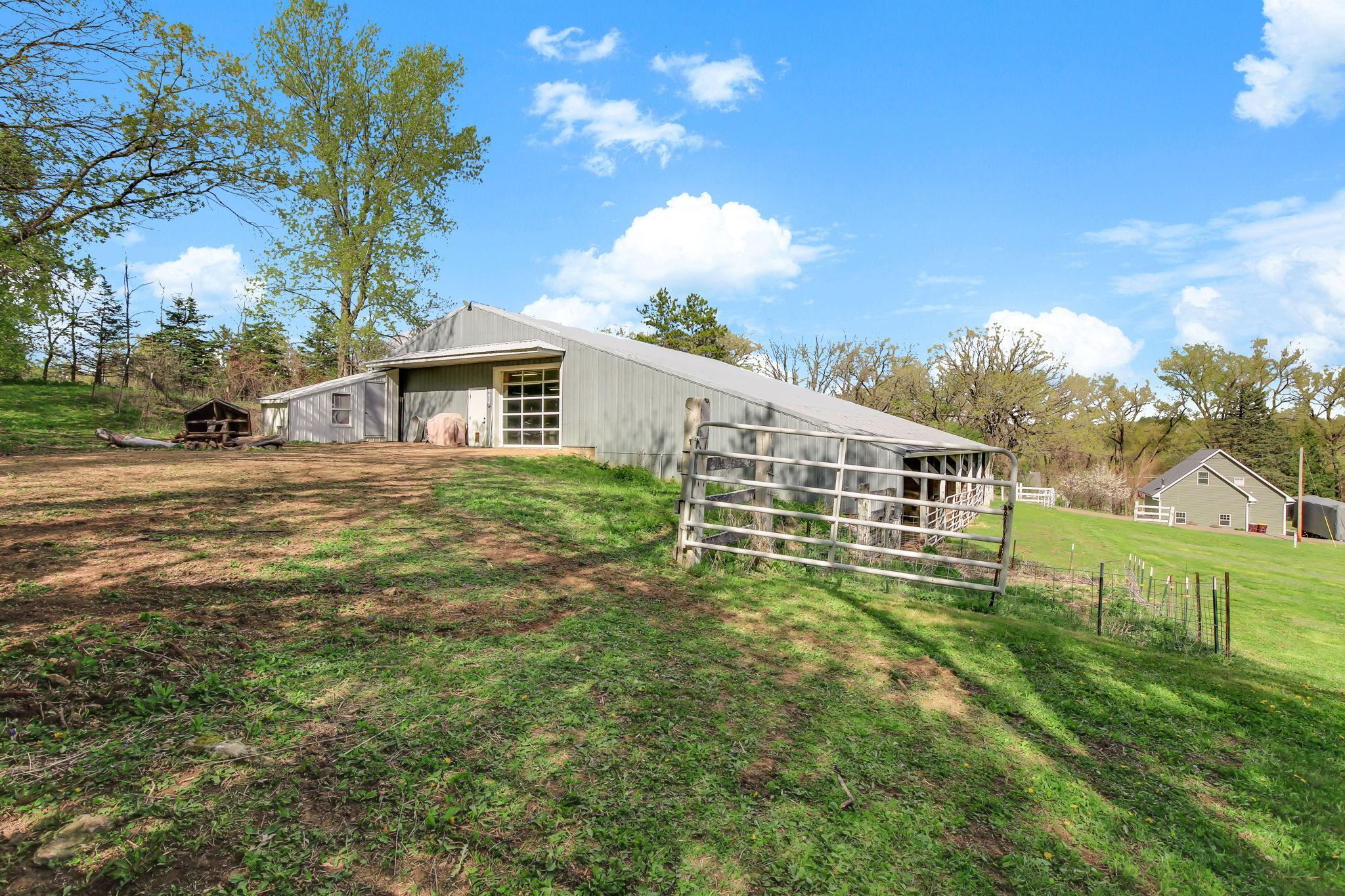 Large Outbuilding with drive-up access - ideal for storage, hobbies, or workshop use. Lower section is set up with stalls and for animals.