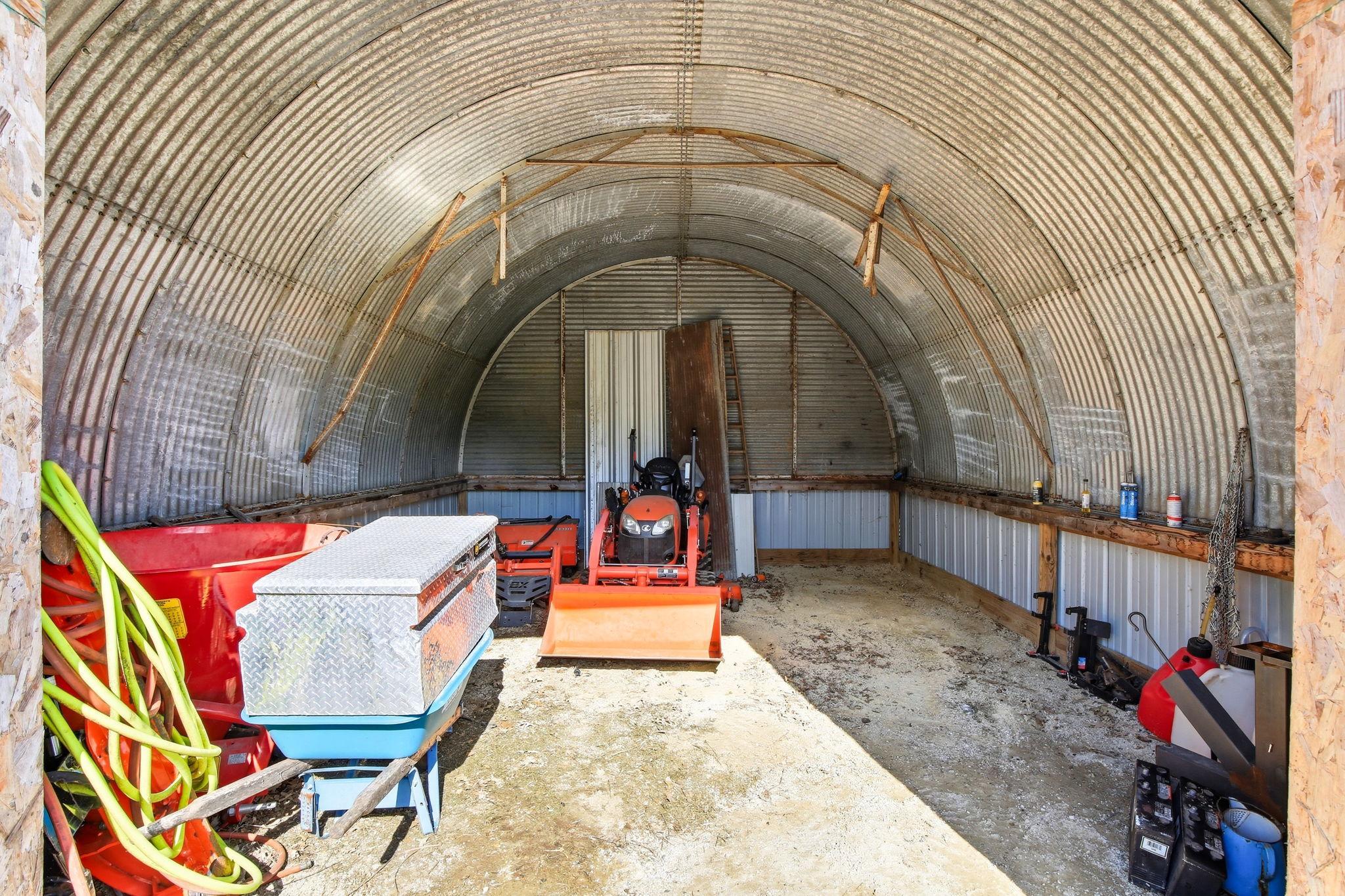 Quonset-style Storage Space with open interior - great for lawn equipment, small machinery, or hobby use.