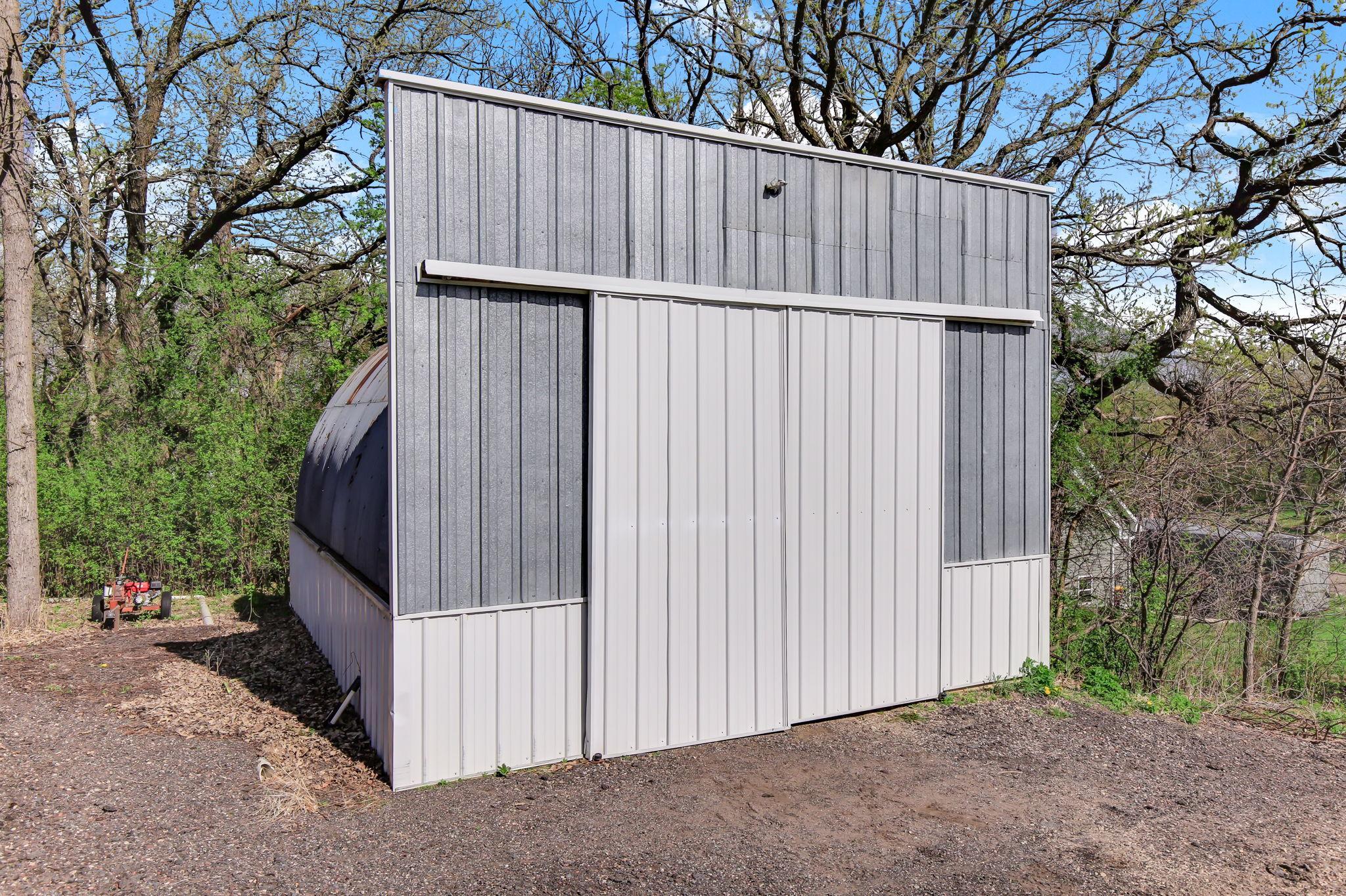 Additional Storage Building with sliding door access - ideal for equipment, tools, or seasonal storage.
