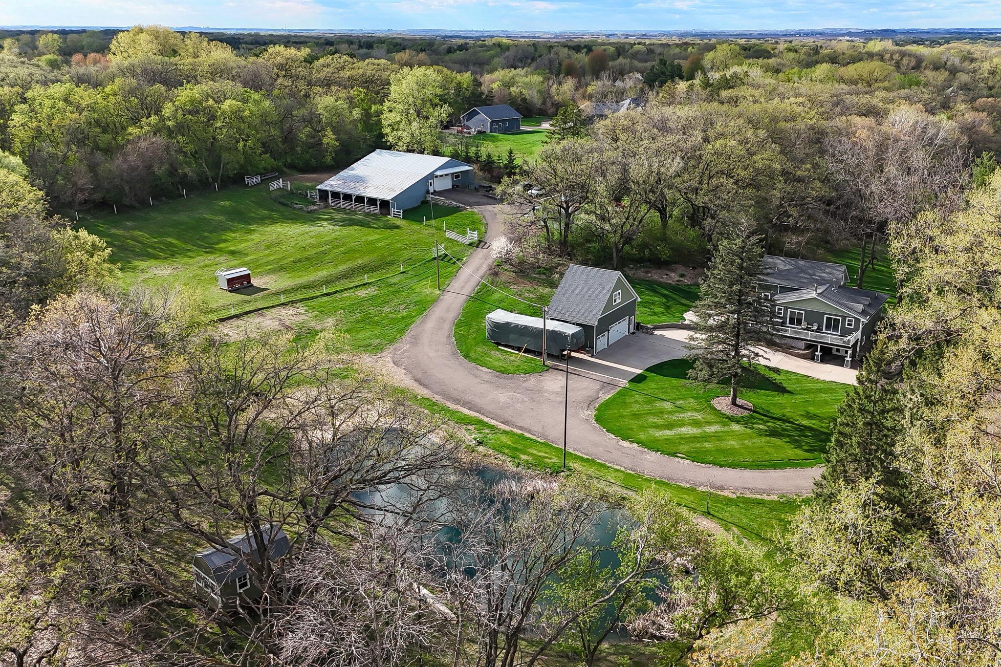 Aerial View showing the full layout - home, outbuildings, pasture areas, and surrounding privacy.