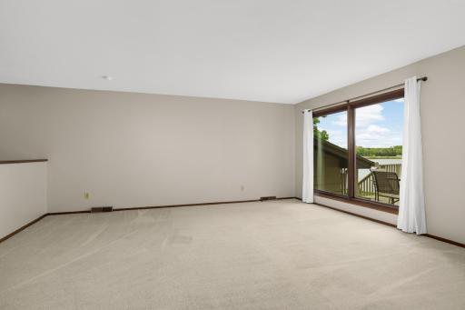 Generous living room centered around beautiful backyard views.