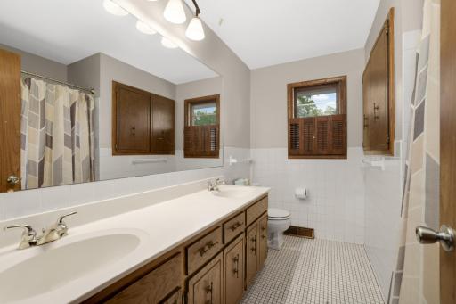 Upper level full bathroom with dual sinks.