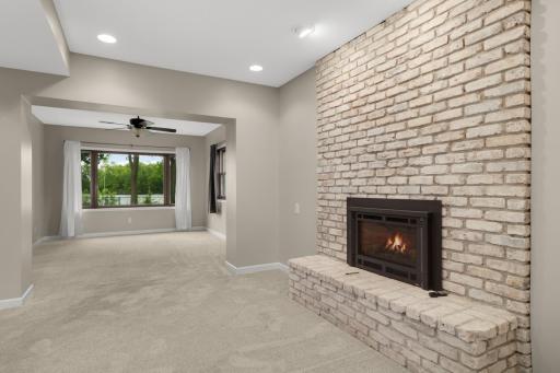 Cozy lower level fireplace creates the perfect gathering space.