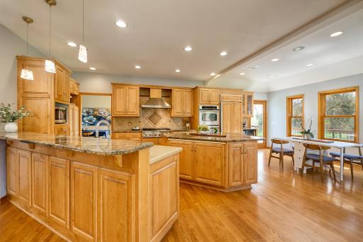 Updated chefâs kitchen features stainless-steel, commercial-grade appliances, custom cabinetry, granite countertops, and rich hardwood floors