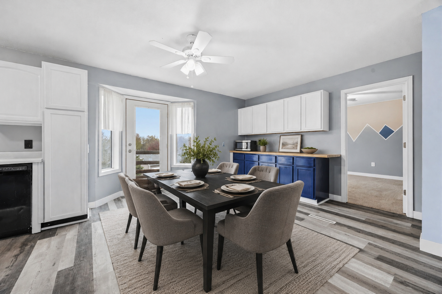 Dining room that provides an open space for entertaining and access to a future deck Virtually Staged