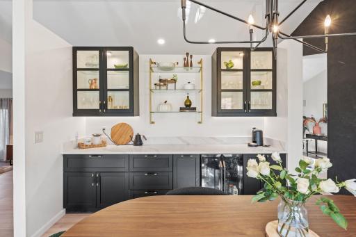Butler's pantry to die for!! Custom built-in cabinets with glass uppers, beverage fridge and quartz countertop.