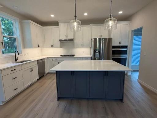 Abundance of custom kitchen cabinets, soft-close drawers and doors, large center island, and beautiful morning pantry with access to large deck perfect for outdoor dining; and for grilling year-round.