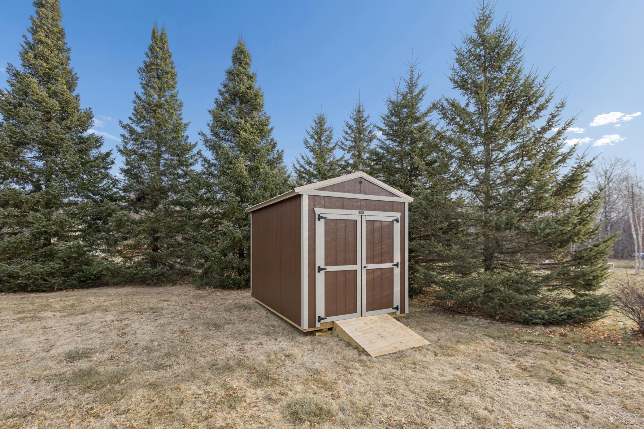 Recently added storage shed perfect for additional yard tools or seasonal storage
