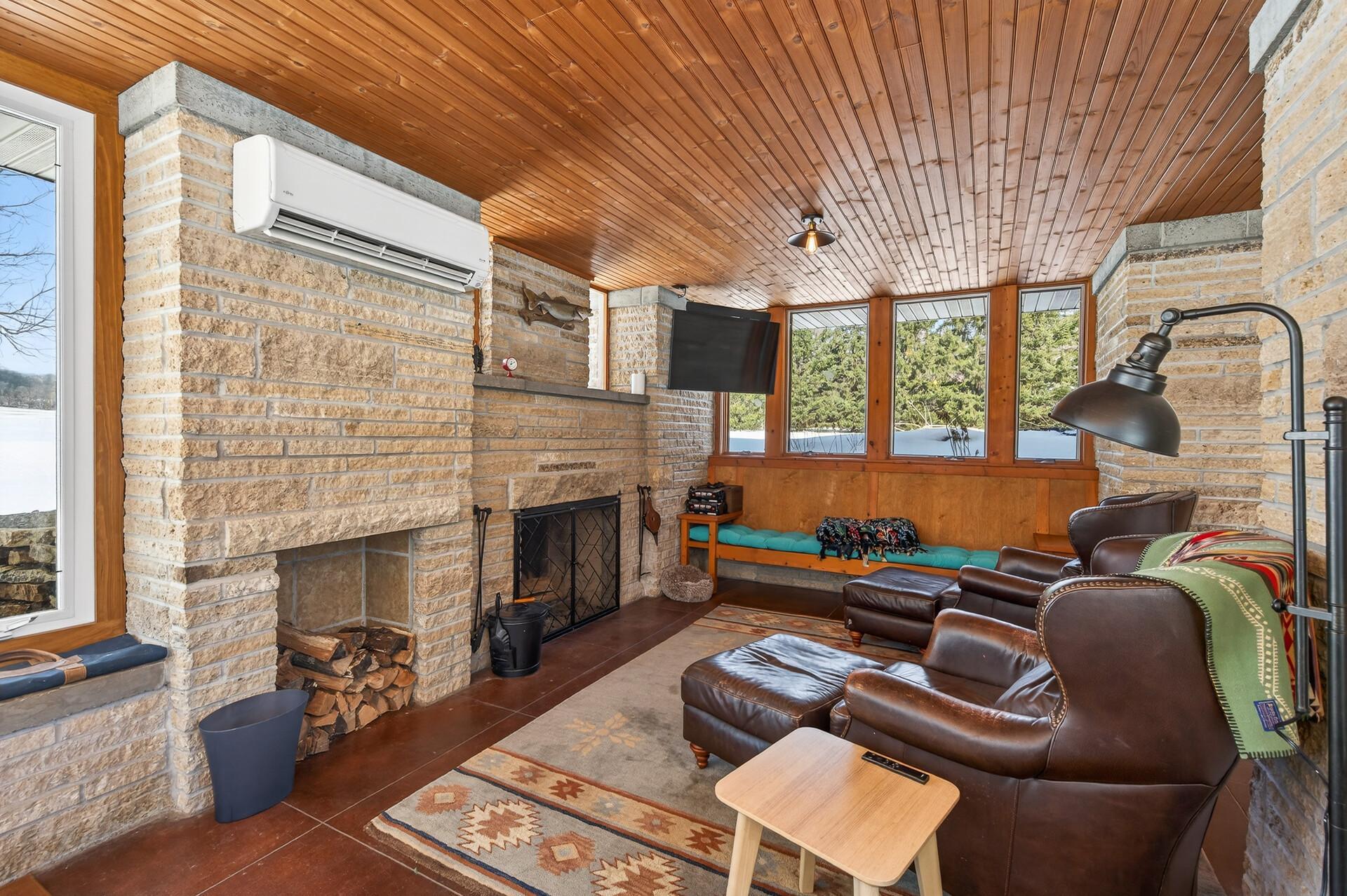 $ season porch with a wood burning fireplace and also a split package unit with Heat and AC