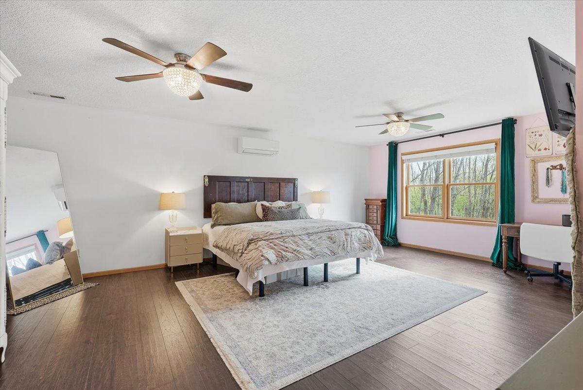 Upperl level primary suite with dual ceiling fans.
