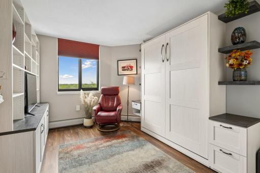Wonderfully appointed, bedroom 2, offers a queen size Murphy bed with nightstand/file drawers, a large media center and large wall closet
