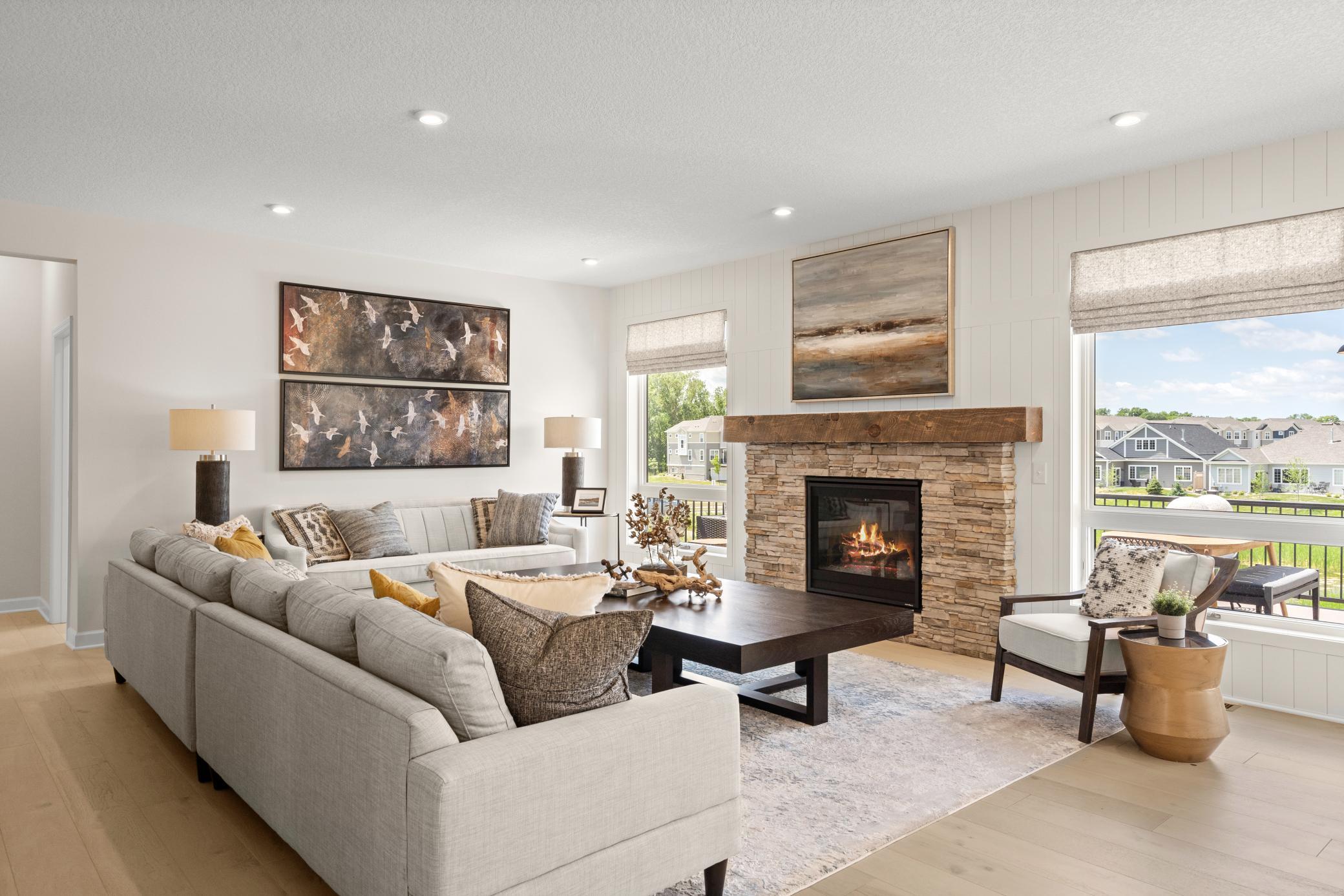 The great room is spacious and has large windows to allow natural light to pour into the home. (model photo)