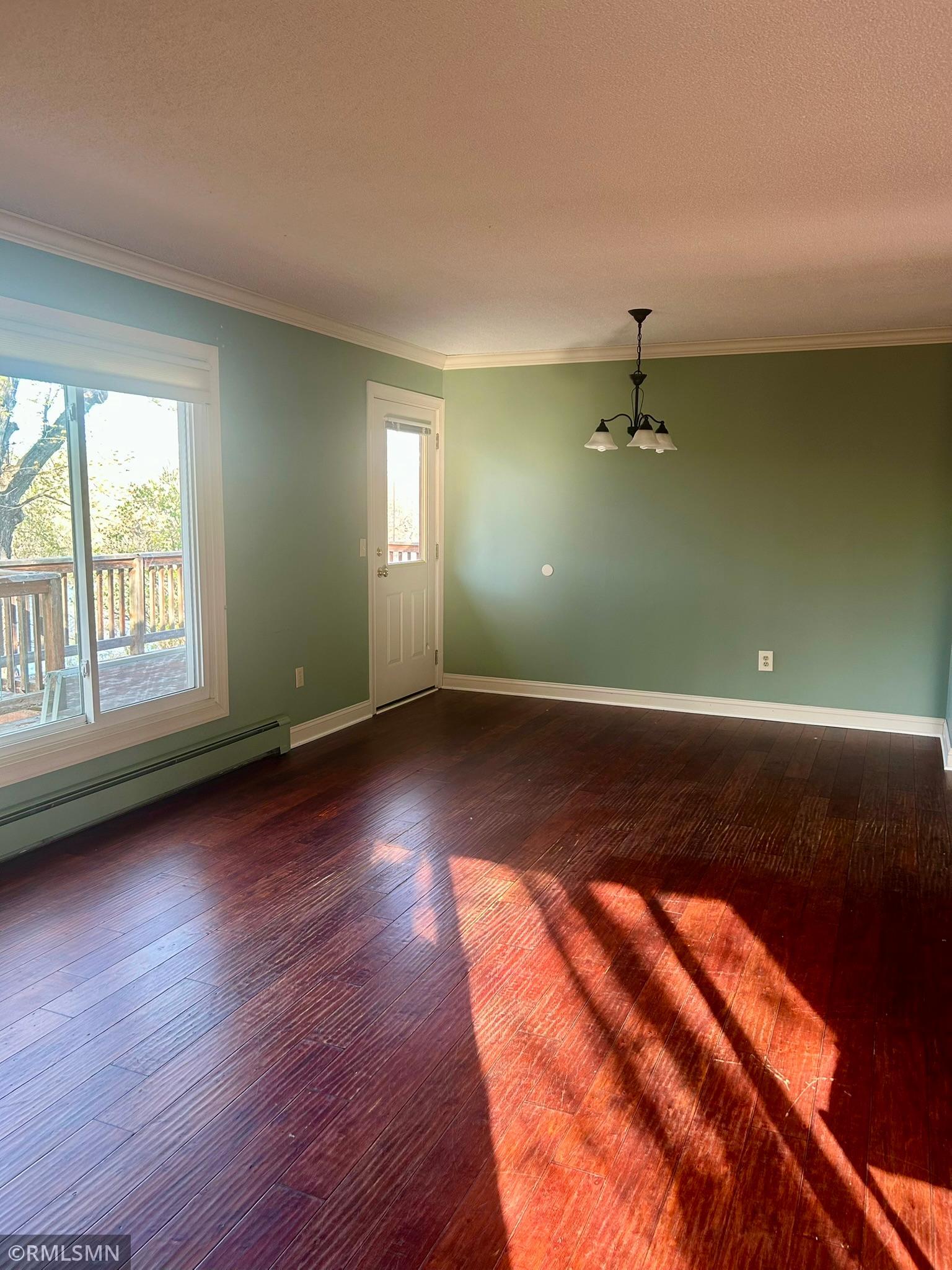 Living room with doorway to deck
