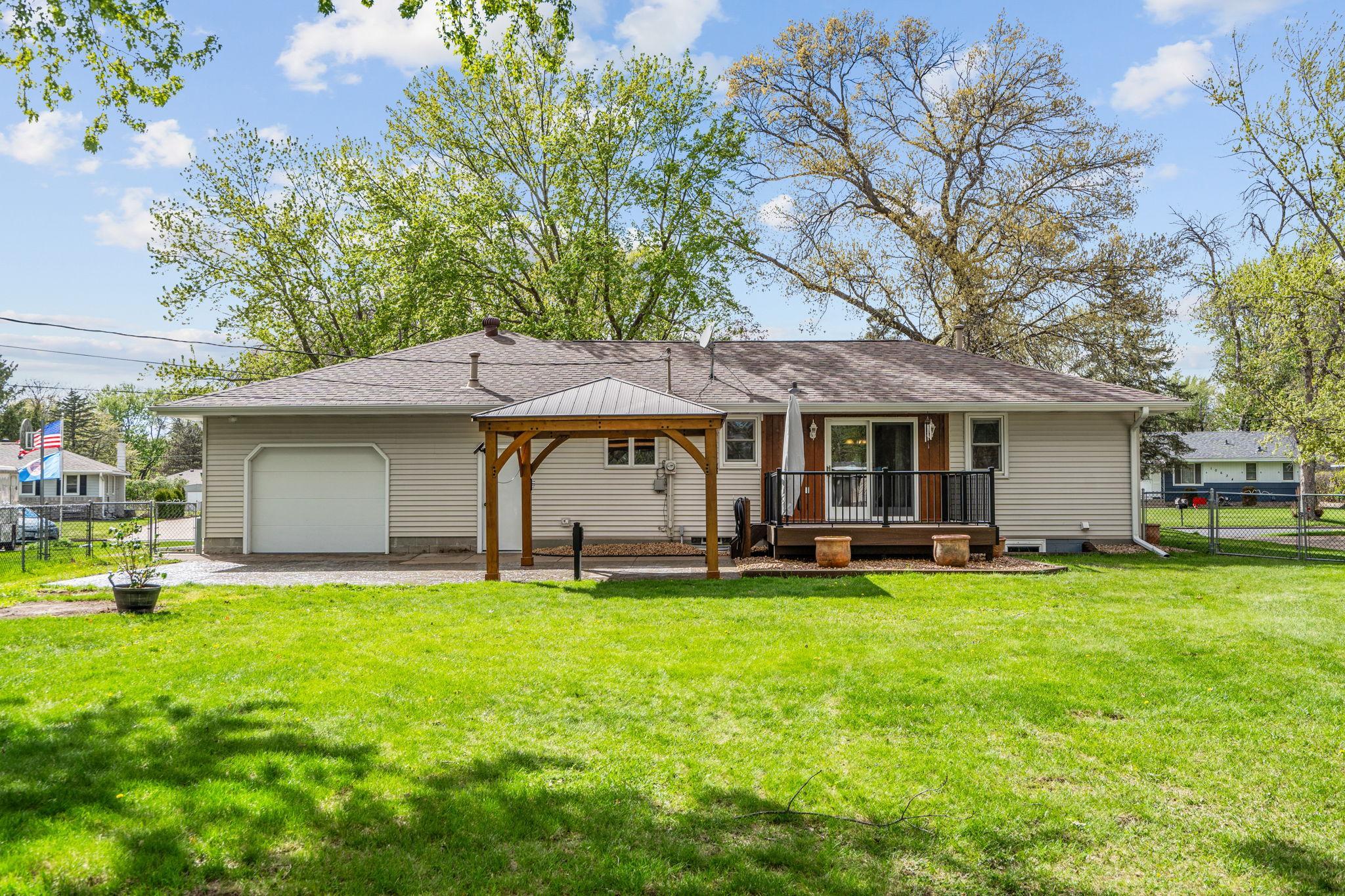 Backyard living space features a gorgeous stamped concrete patio, gazebo, and hot tub hook up!