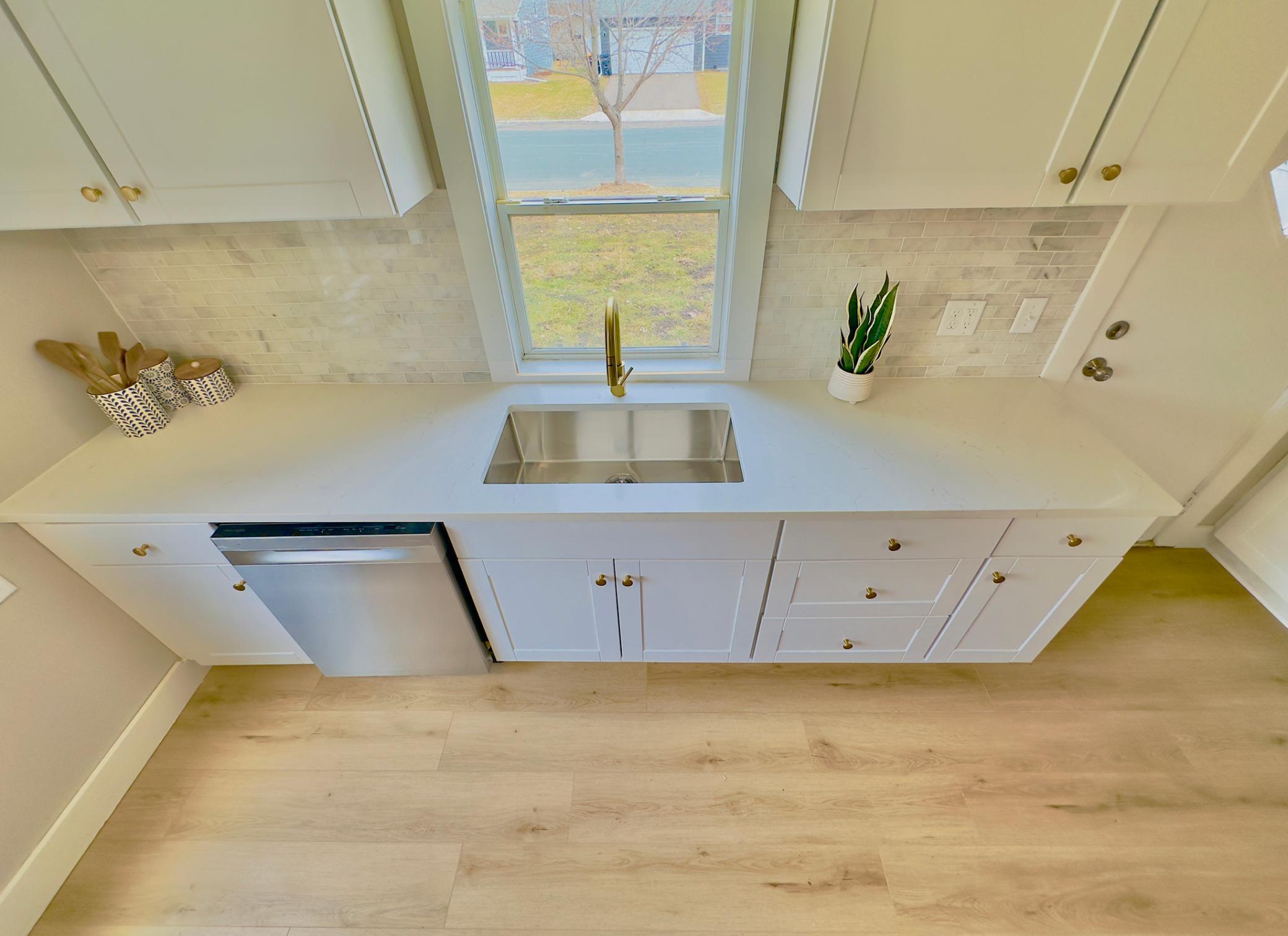 New quartz counters and natural stone backsplash