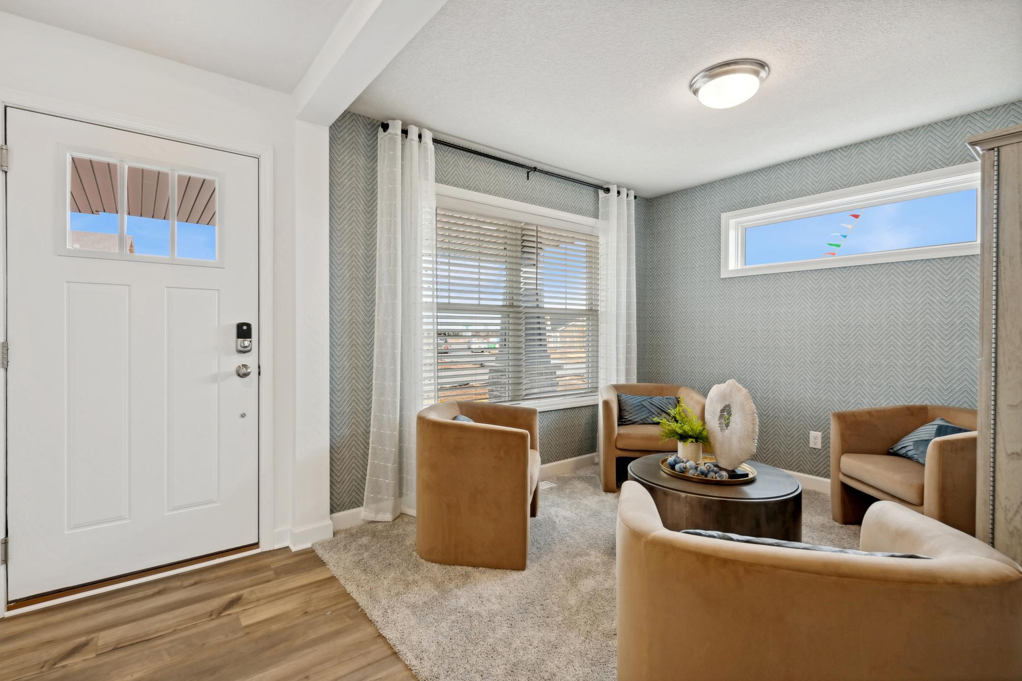 (Photo of decorated model, actual home's finishes will vary) A spacious flex room is located at the foyer offering a nice work from home space, or a formal living room area.