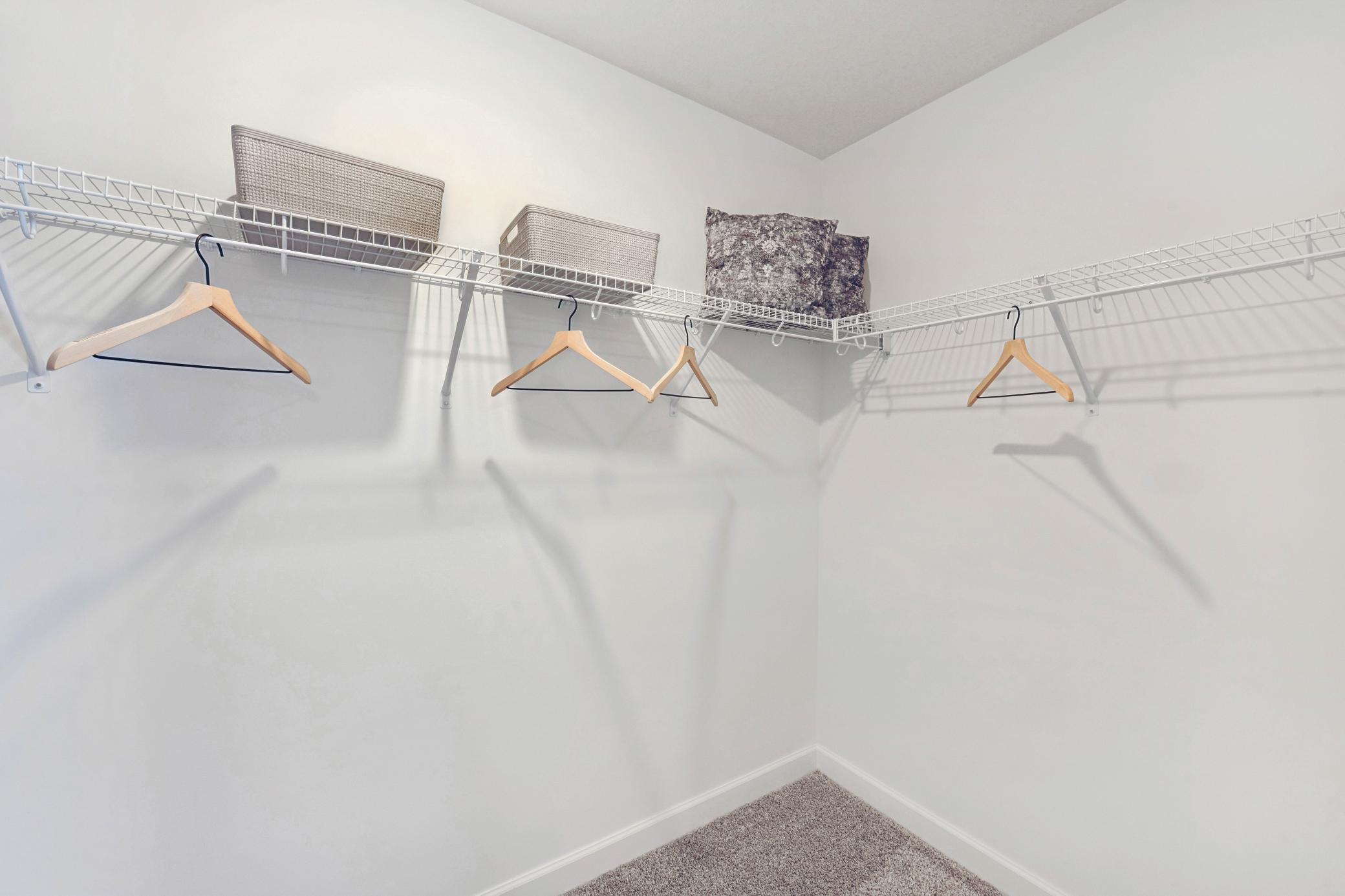 (Photo of decorated model, actual home's finishes will vary) The owner's suite features an incredible walk-in closet.