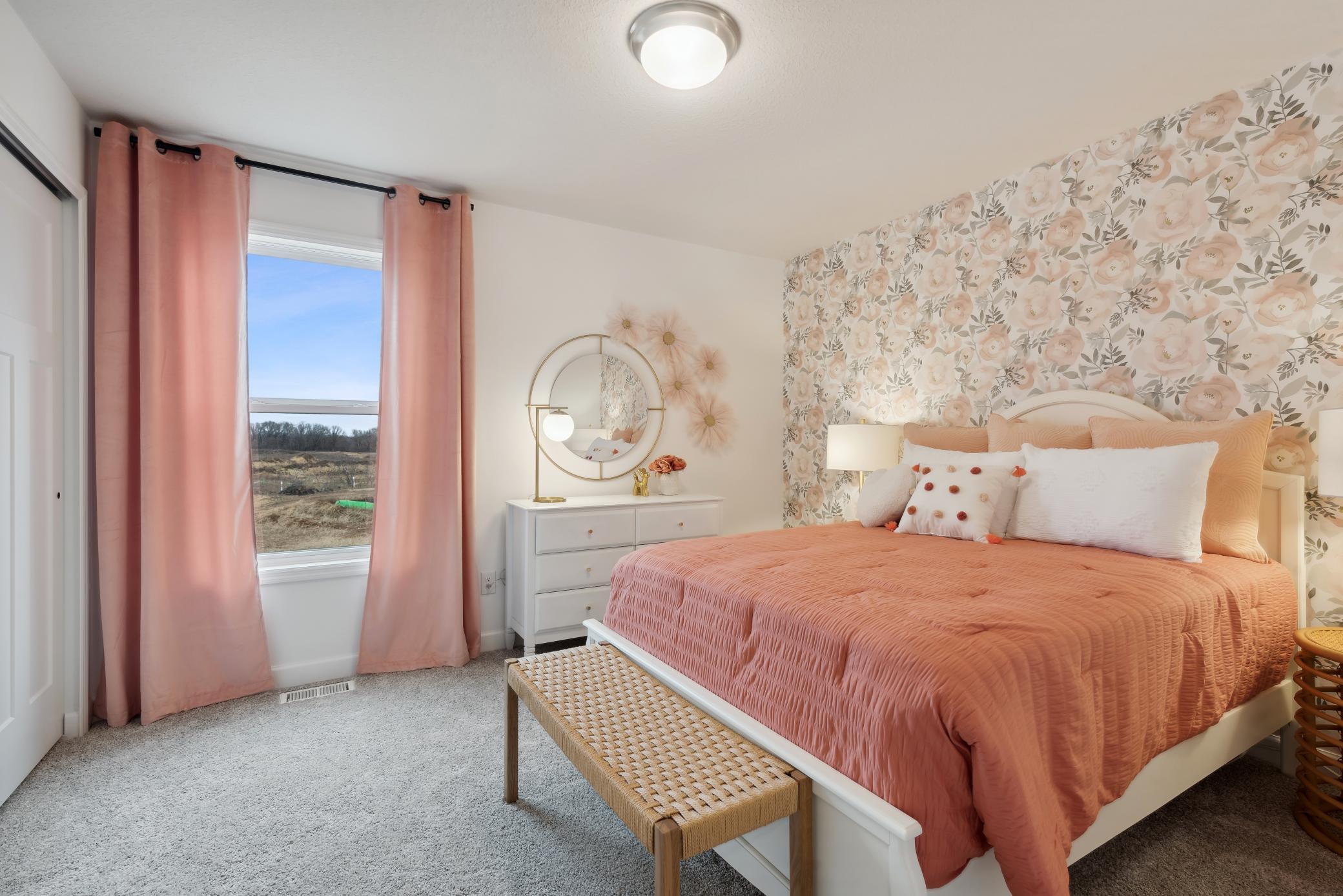 (Photo of decorated model, actual home's finishes will vary) One of three generously sized secondary bedrooms.