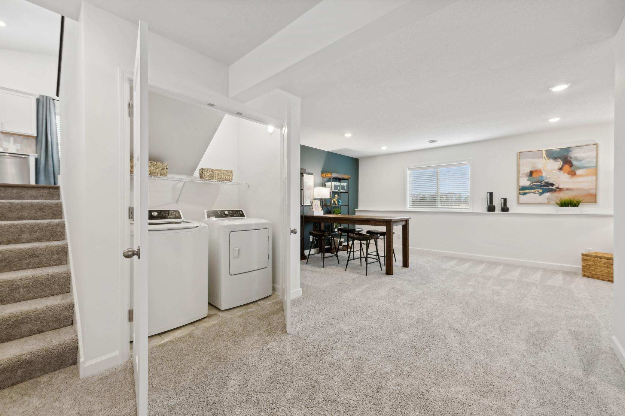 (Photo of decorated model, actual home's finishes will vary) Located in the optional finished basement is a laundry room to get chores finished and keep messes out of sight.