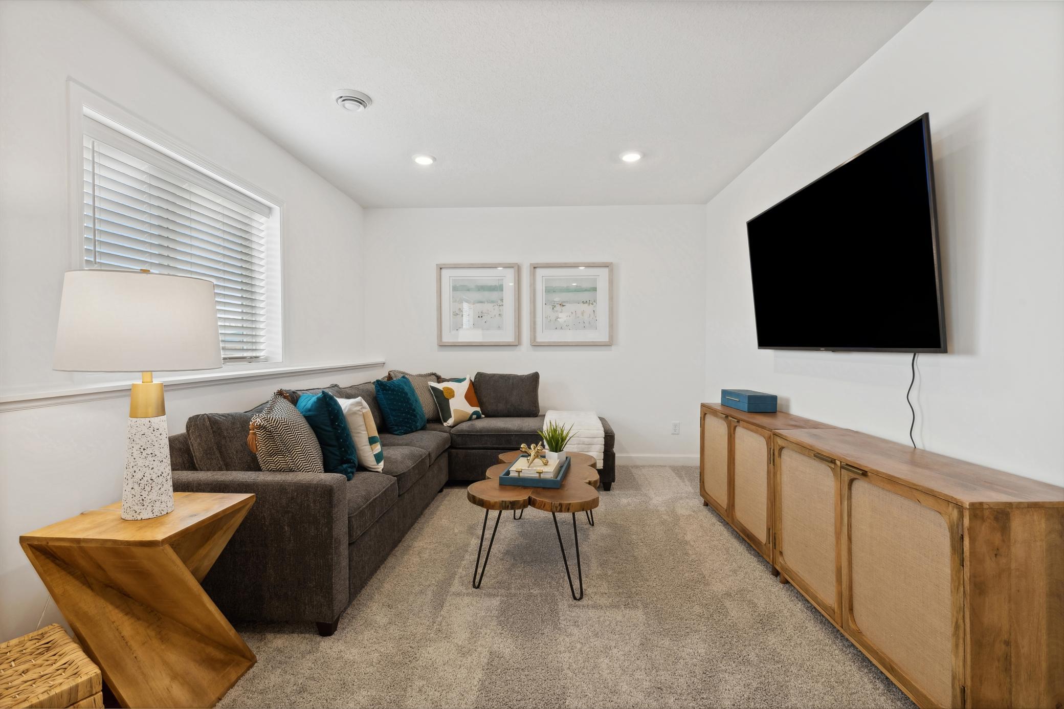 (Photo of decorated model, actual home's finishes will vary) The recreation room can function as the ultimate entertainment space and at-home movie theater.