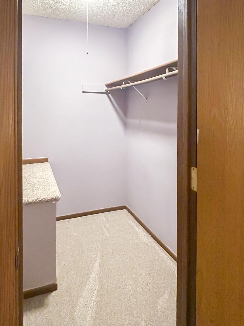 Primary bedroom walk-in closet