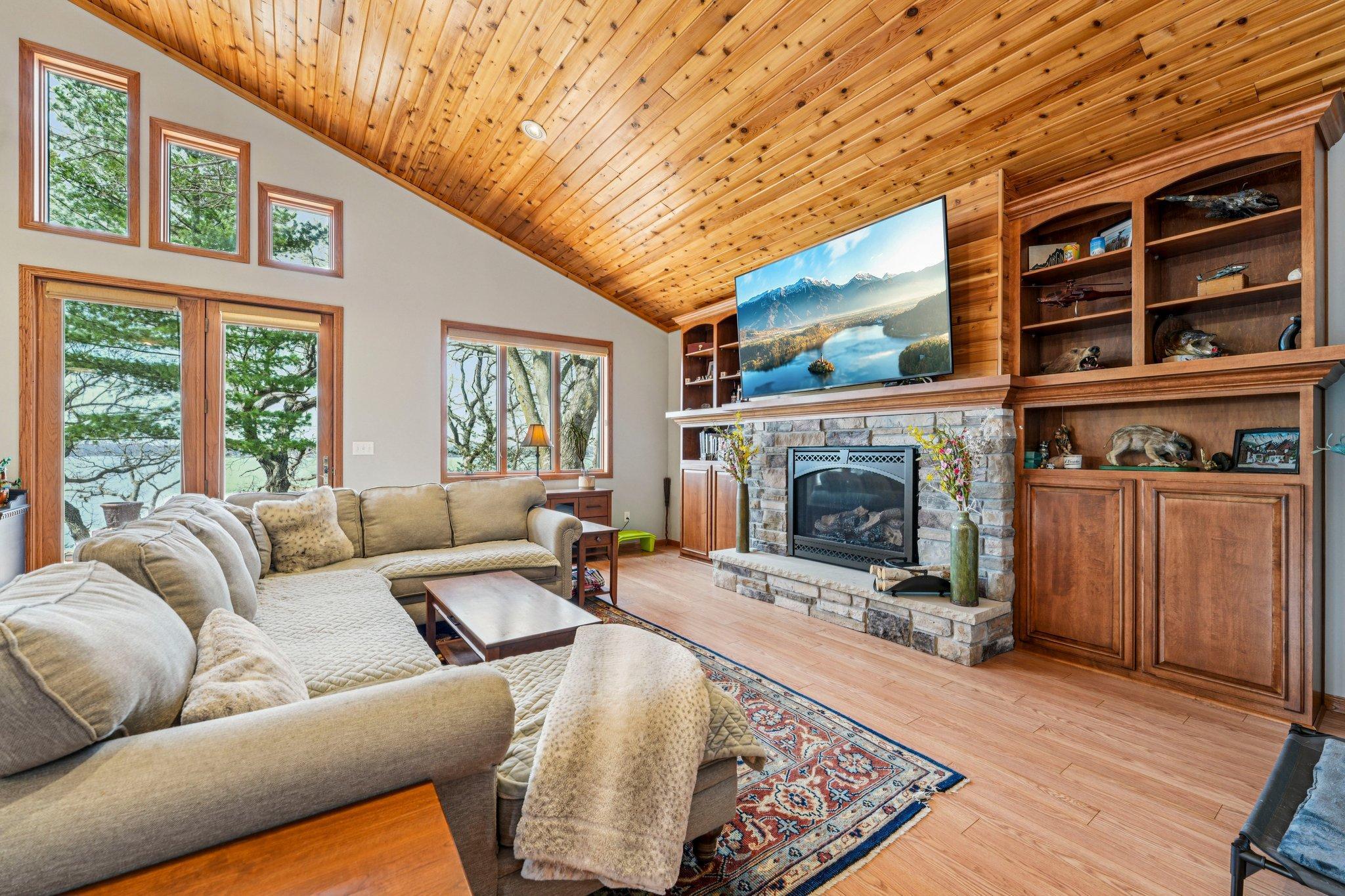 Cozy up next to the fireplace with lake views