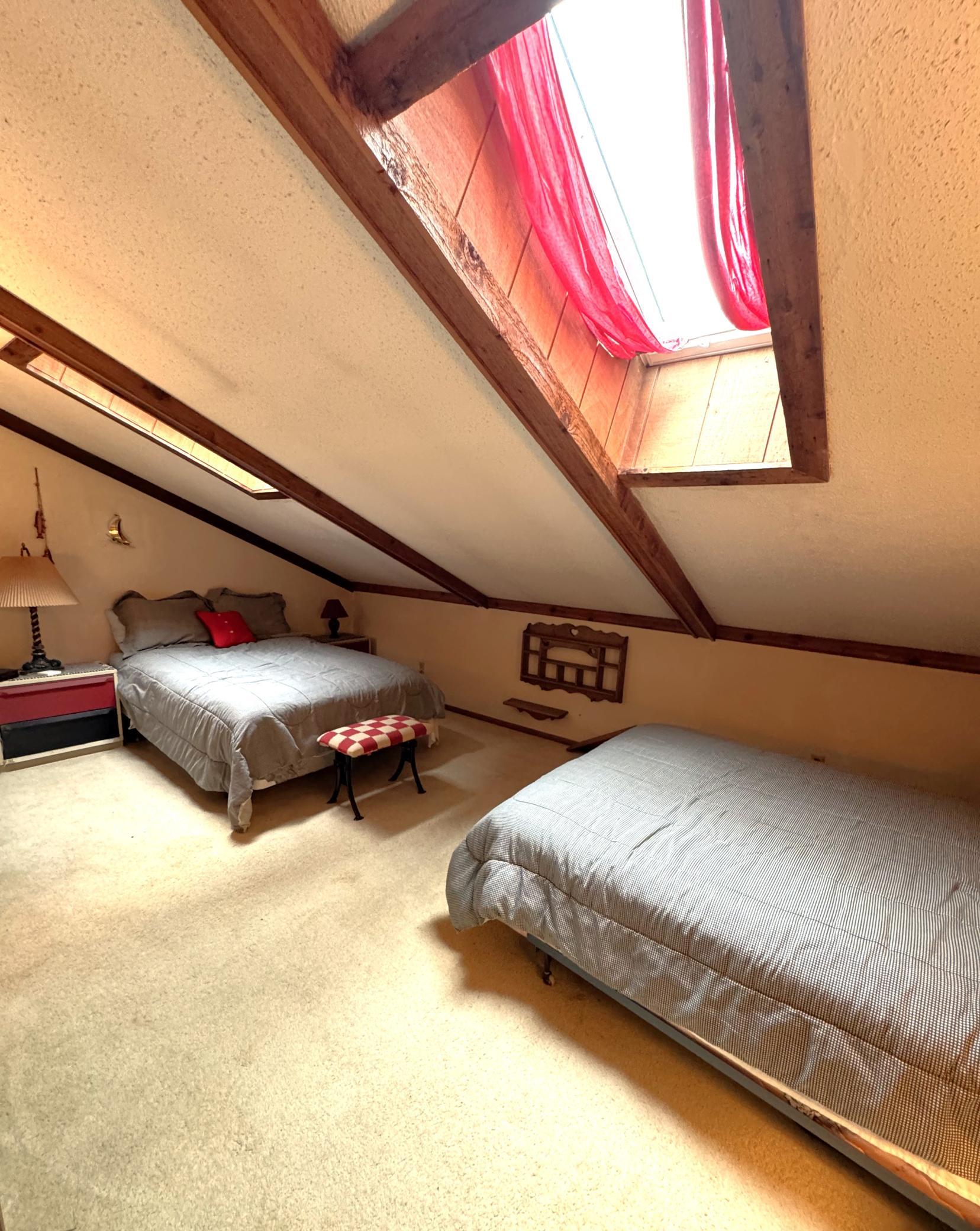 Loft area provides additional sleeping space. The skylights were installed just a couple years ago and provide lots of natural light. Curtains are on the skylights if you choose to use them.