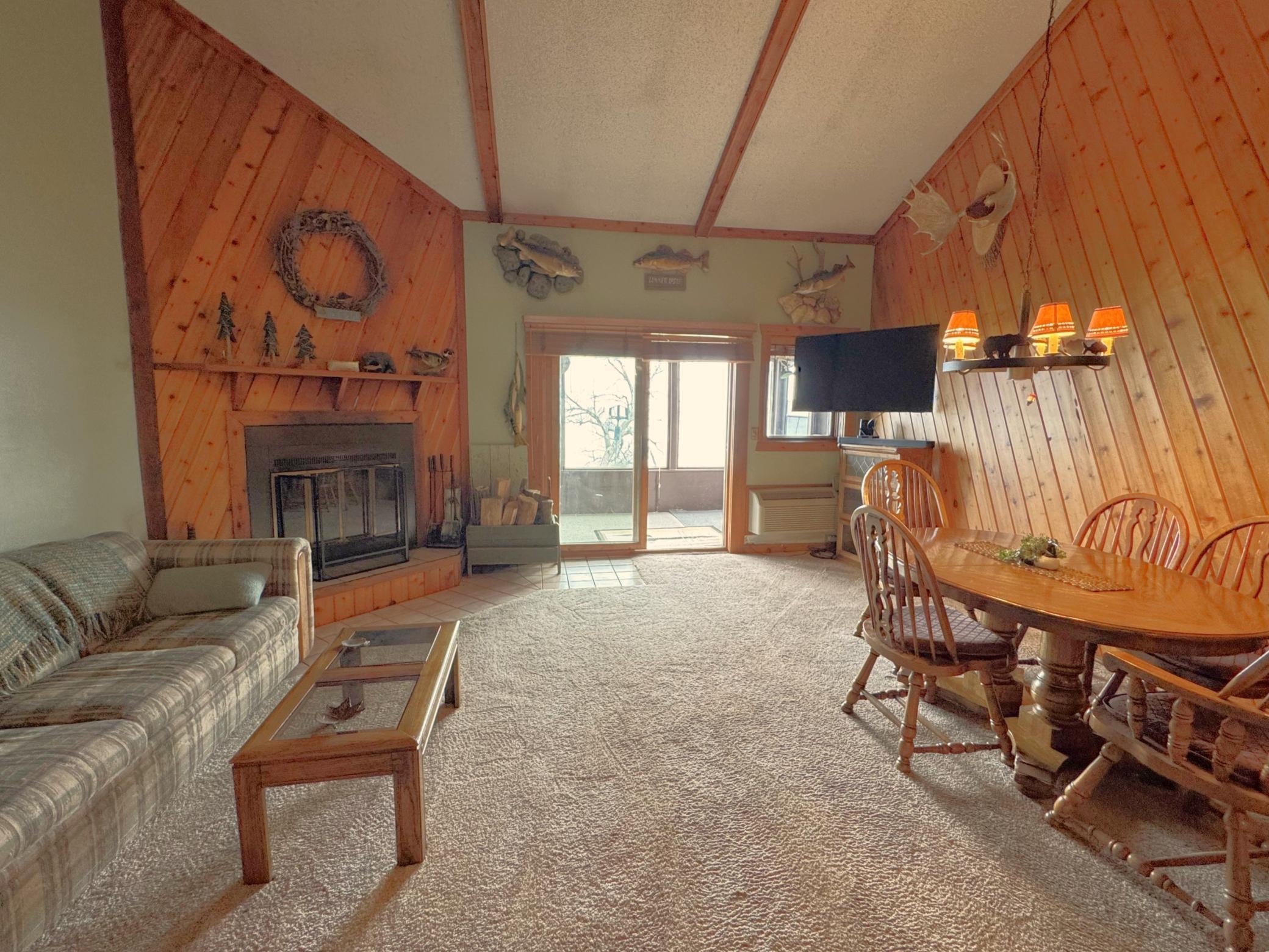 Nice size family room with lots of knotty pine accent.