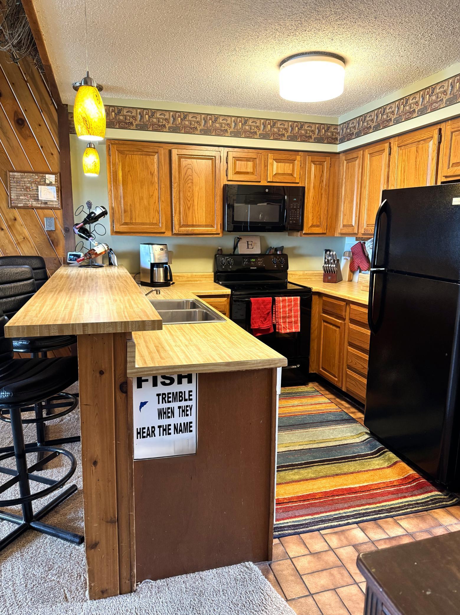 Lots of cabinets to store those kitchen essentials. The raised bar is perfect for those quick meals.