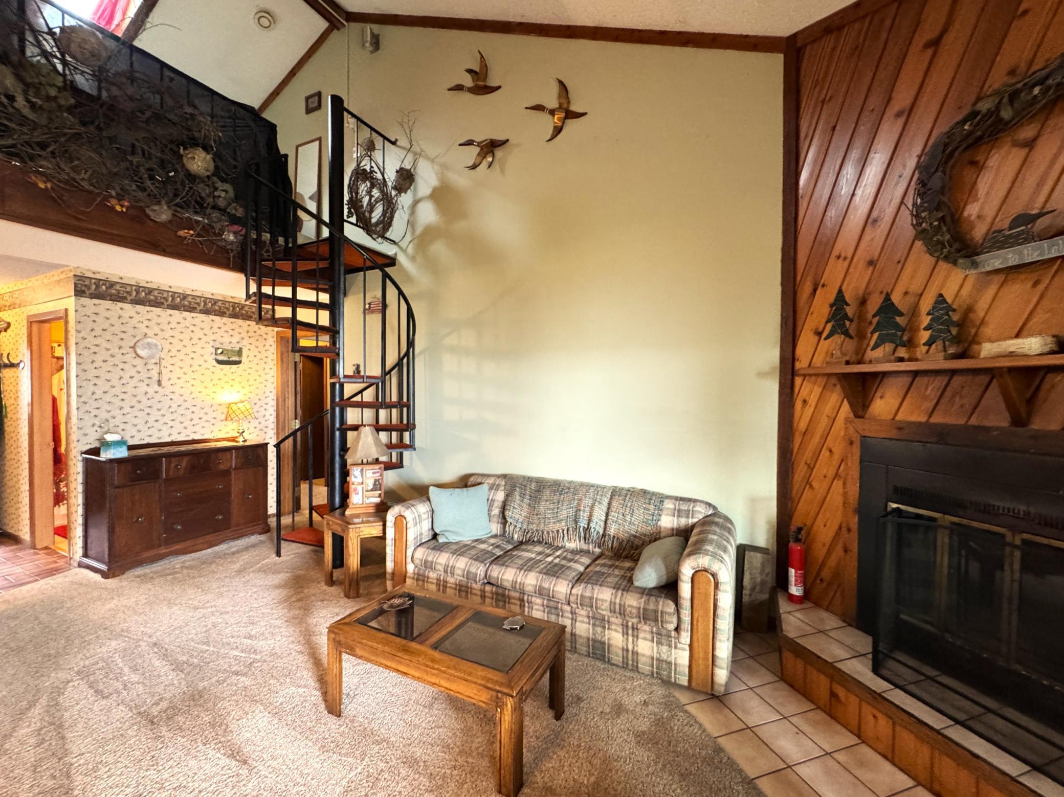 The circular stairs lead to the loft area.
