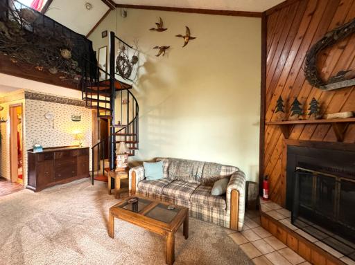 The circular stairs lead to the loft area. The vaulted ceiling makes it feel so open..