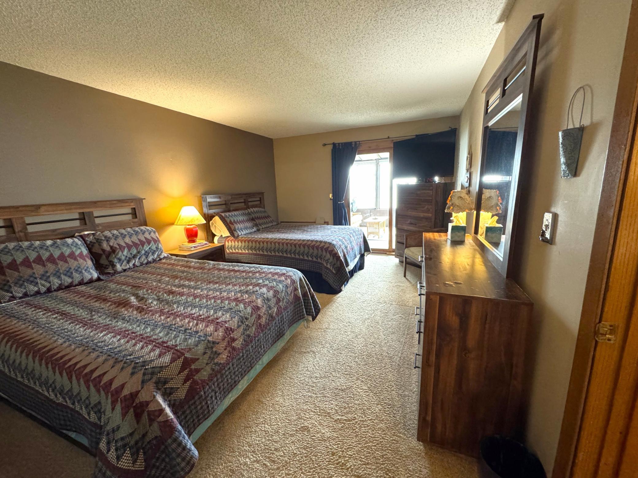 Main floor bedroom with plenty of room for the family. Patio door leads to the other side of the lakeside porch.