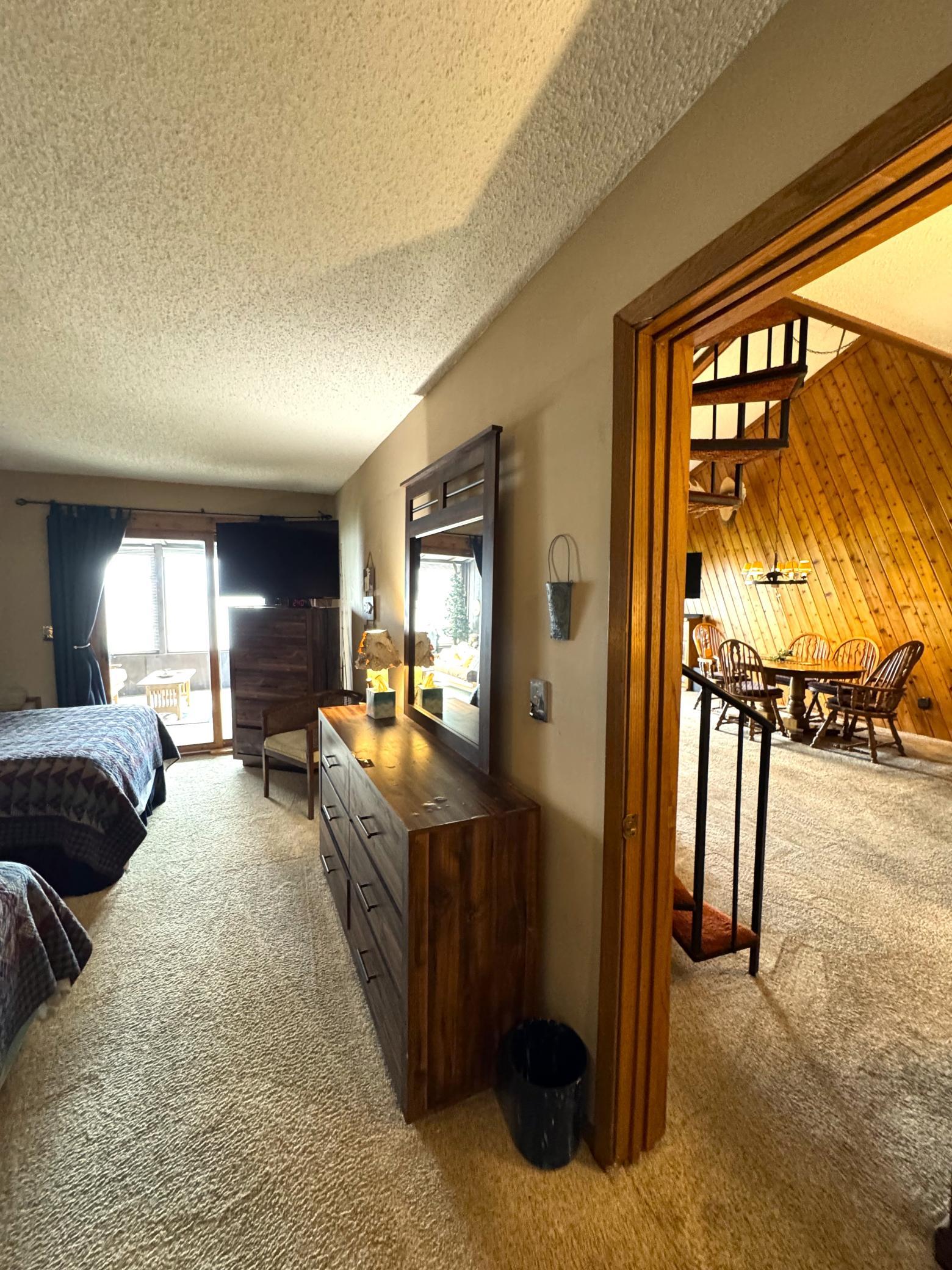 The main floor bedroom entrance is right next to the circular stairs.